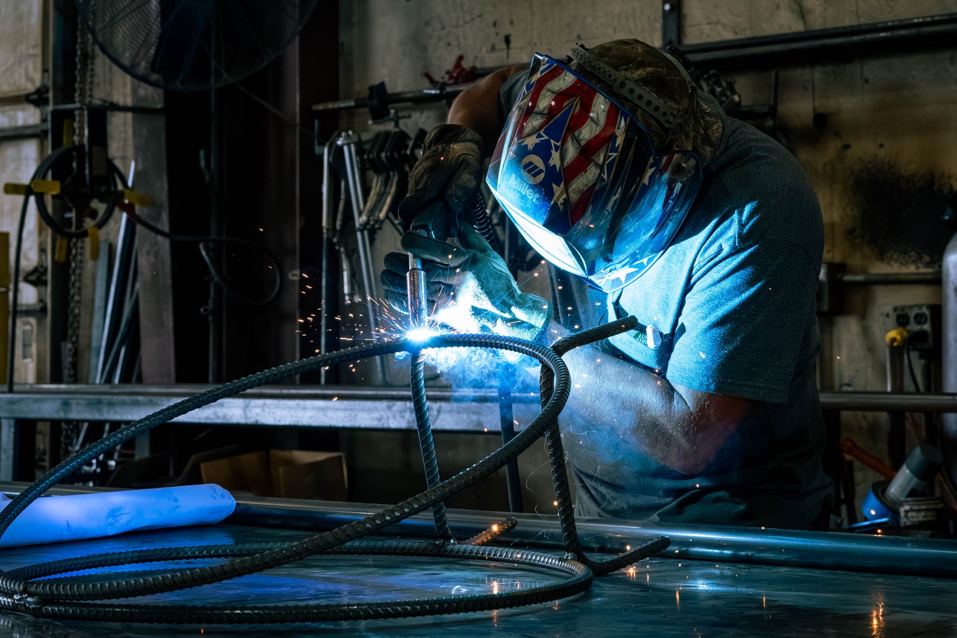 Fabricator grinding steel tubing in the DeVille Steel shop